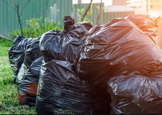 Black garbage bags ready for pickup as part of our garbage removal services in Calgary